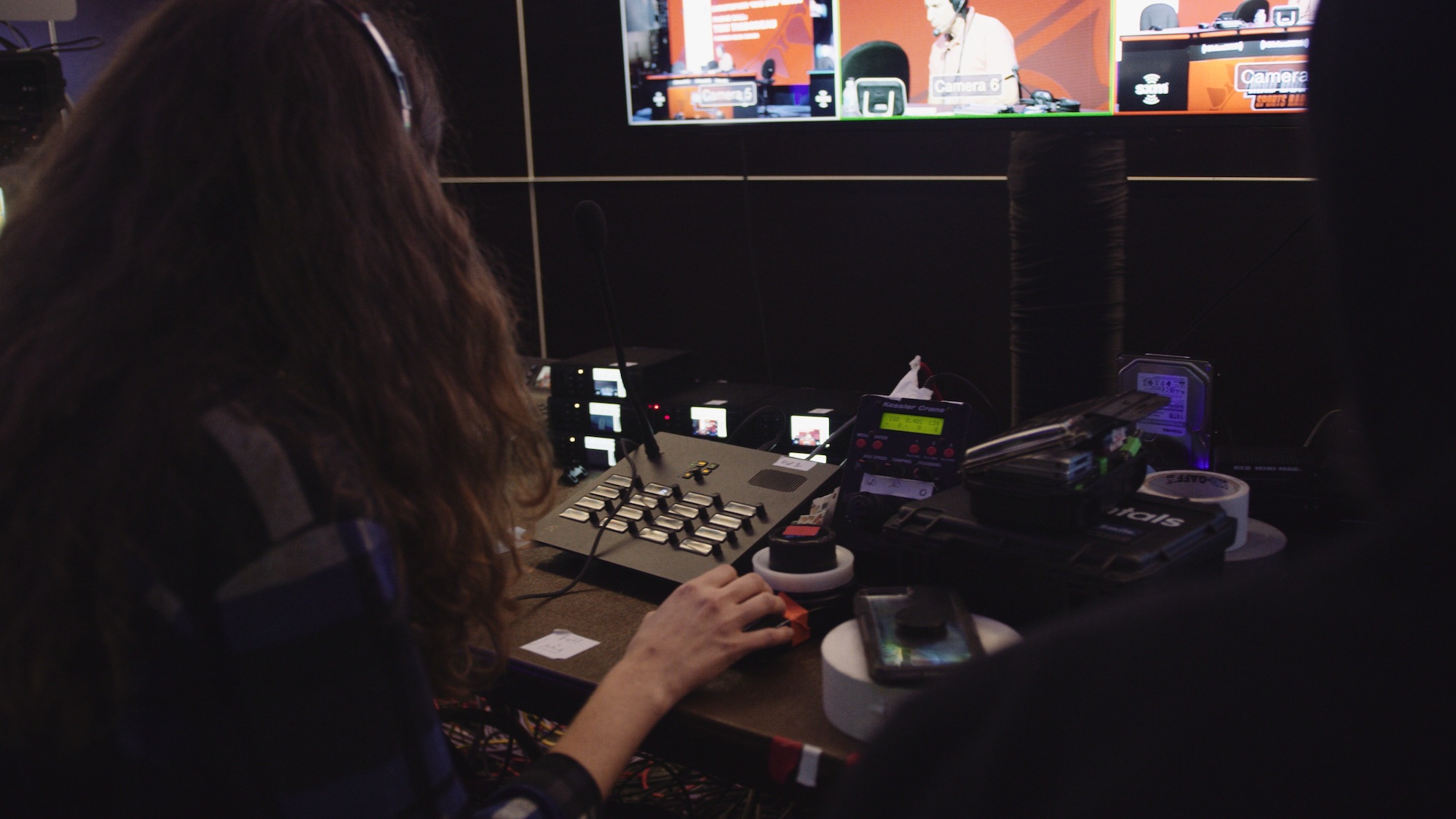 Side profile of woman with long brown hair looking at video bank working with Livestream