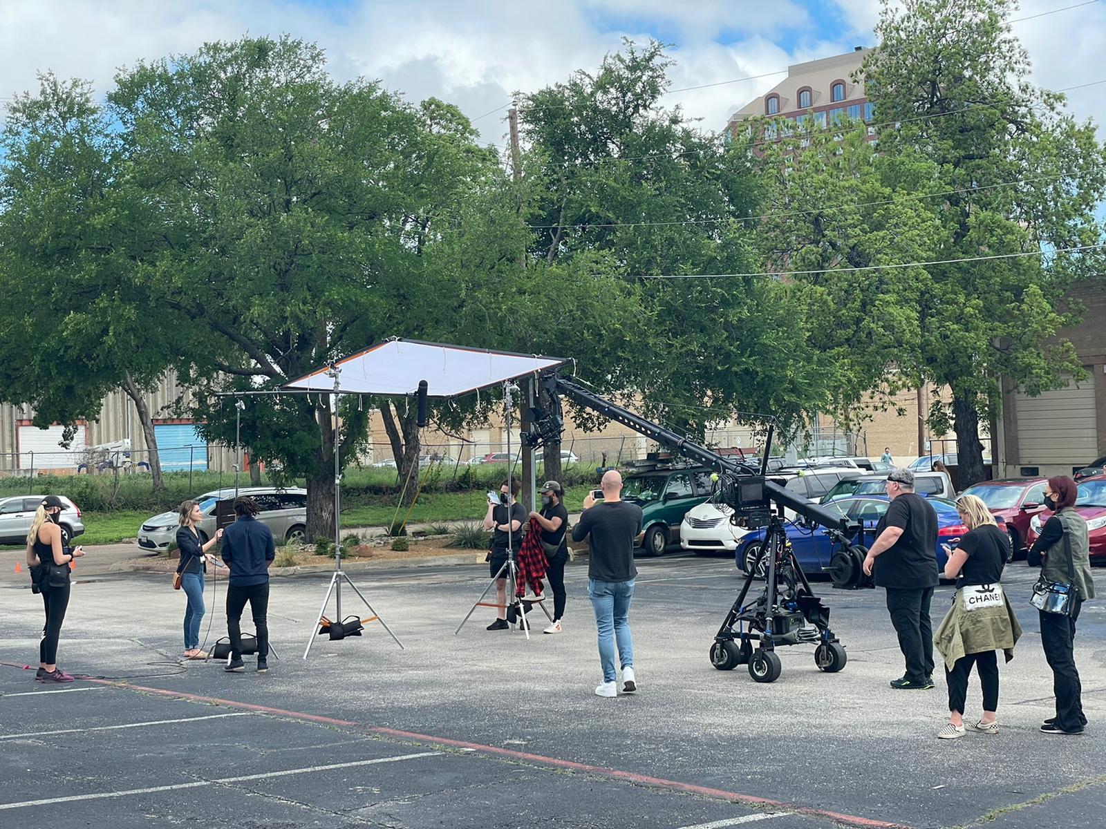 Crew members working on a set in a parking lot