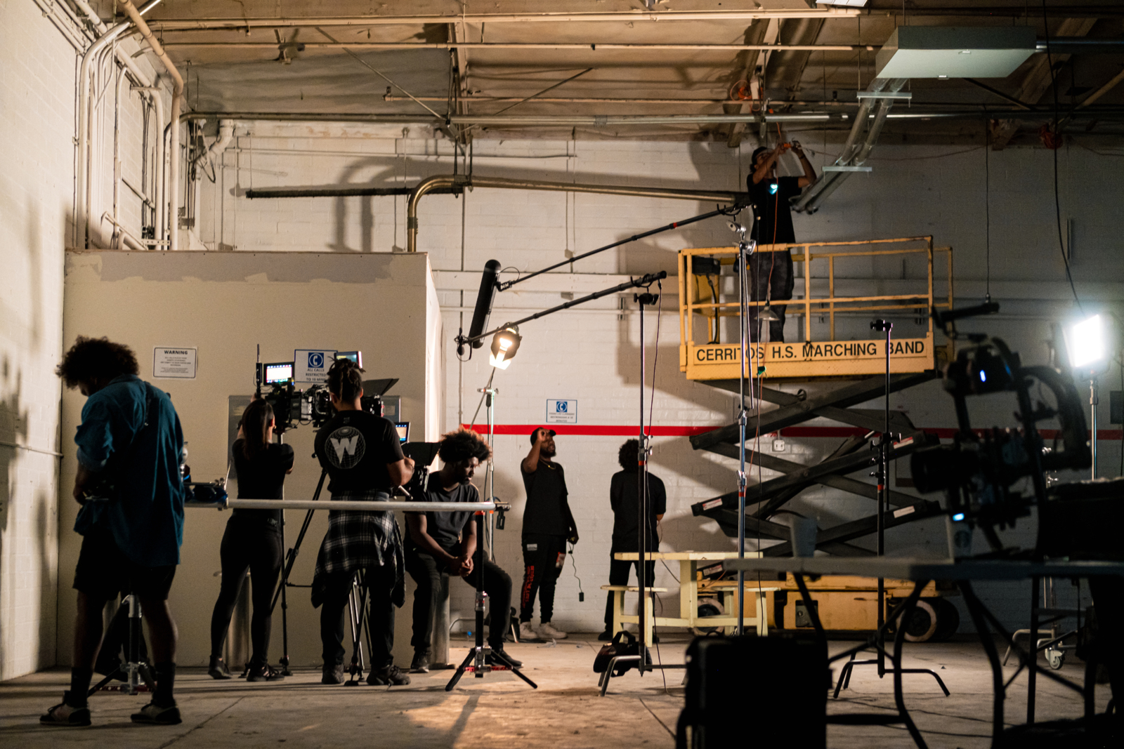 The Benefits of Working with an Established Crew on Your Film Crew members setting up a set