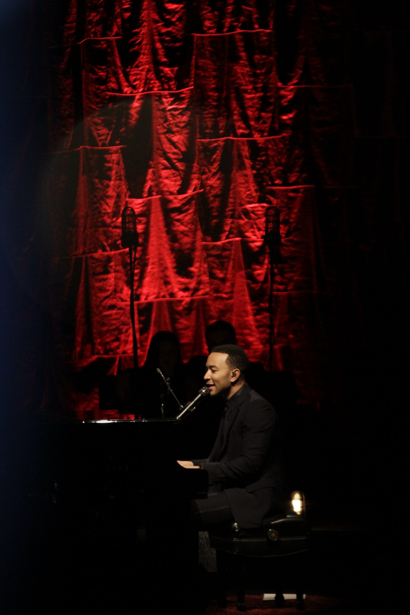 Side profile of John Legend on stage