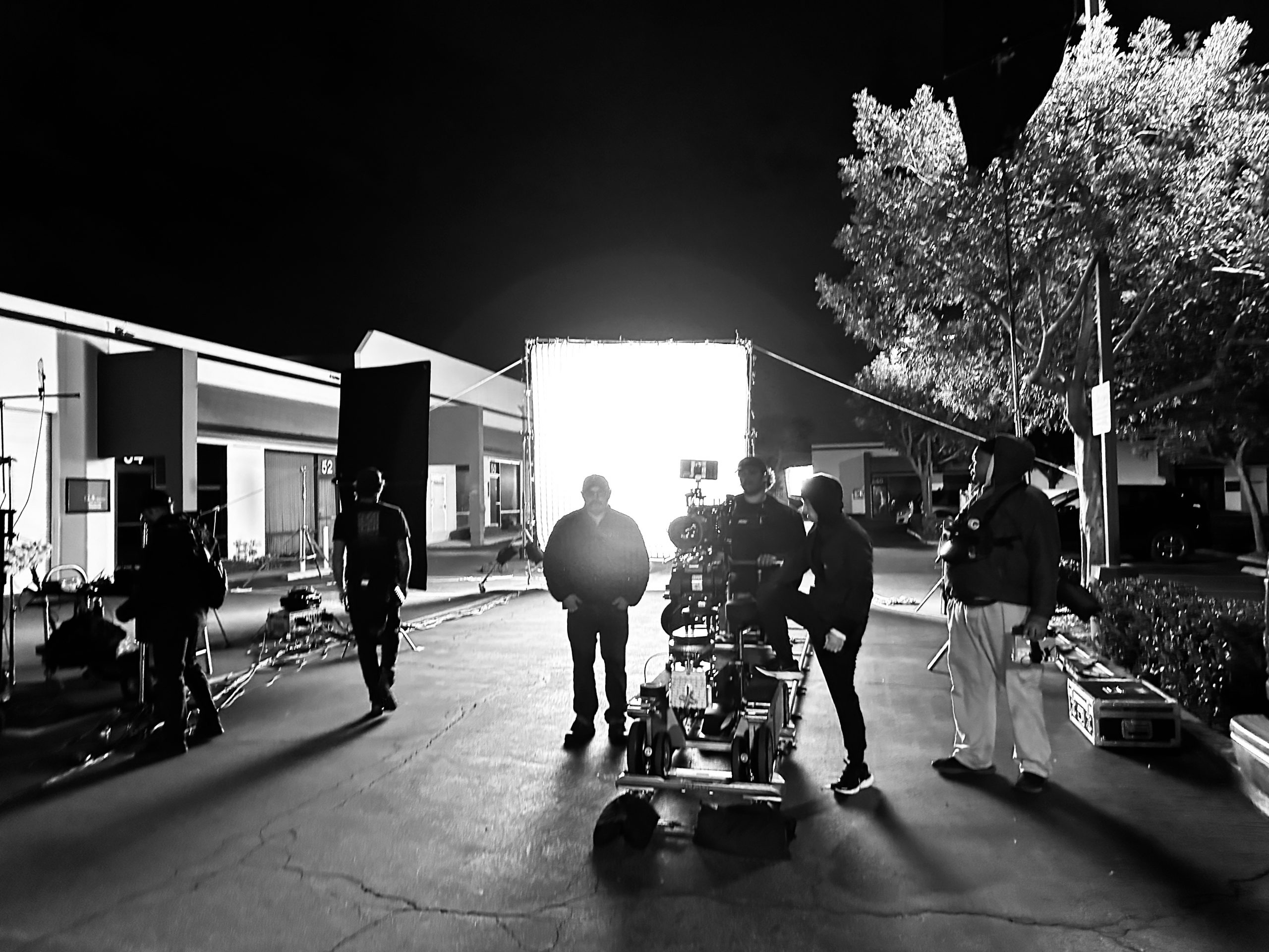 What is a Fixer Black and white of crew members working with a video camera on a set outside