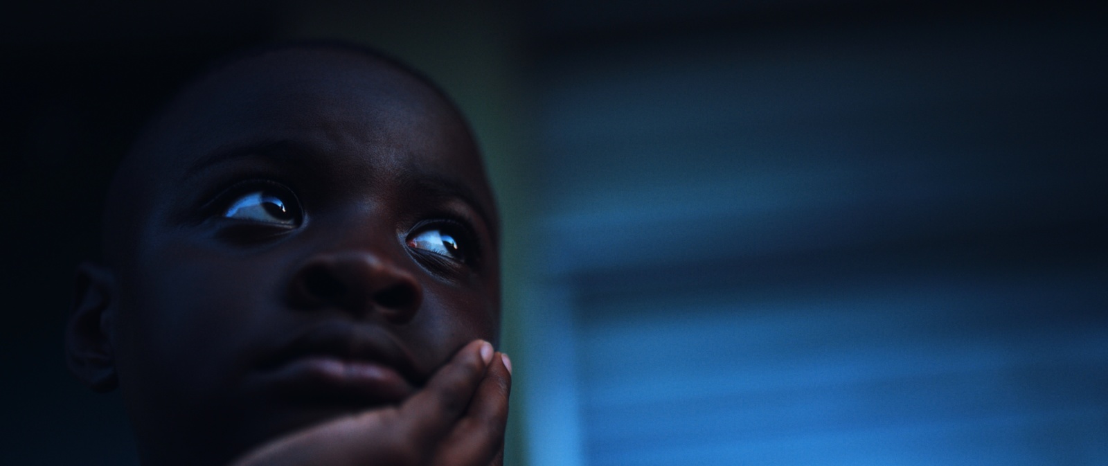 The Role of Color Grading in Film and TV Production Headshot of African American boy looking off to the side with hand under his chin