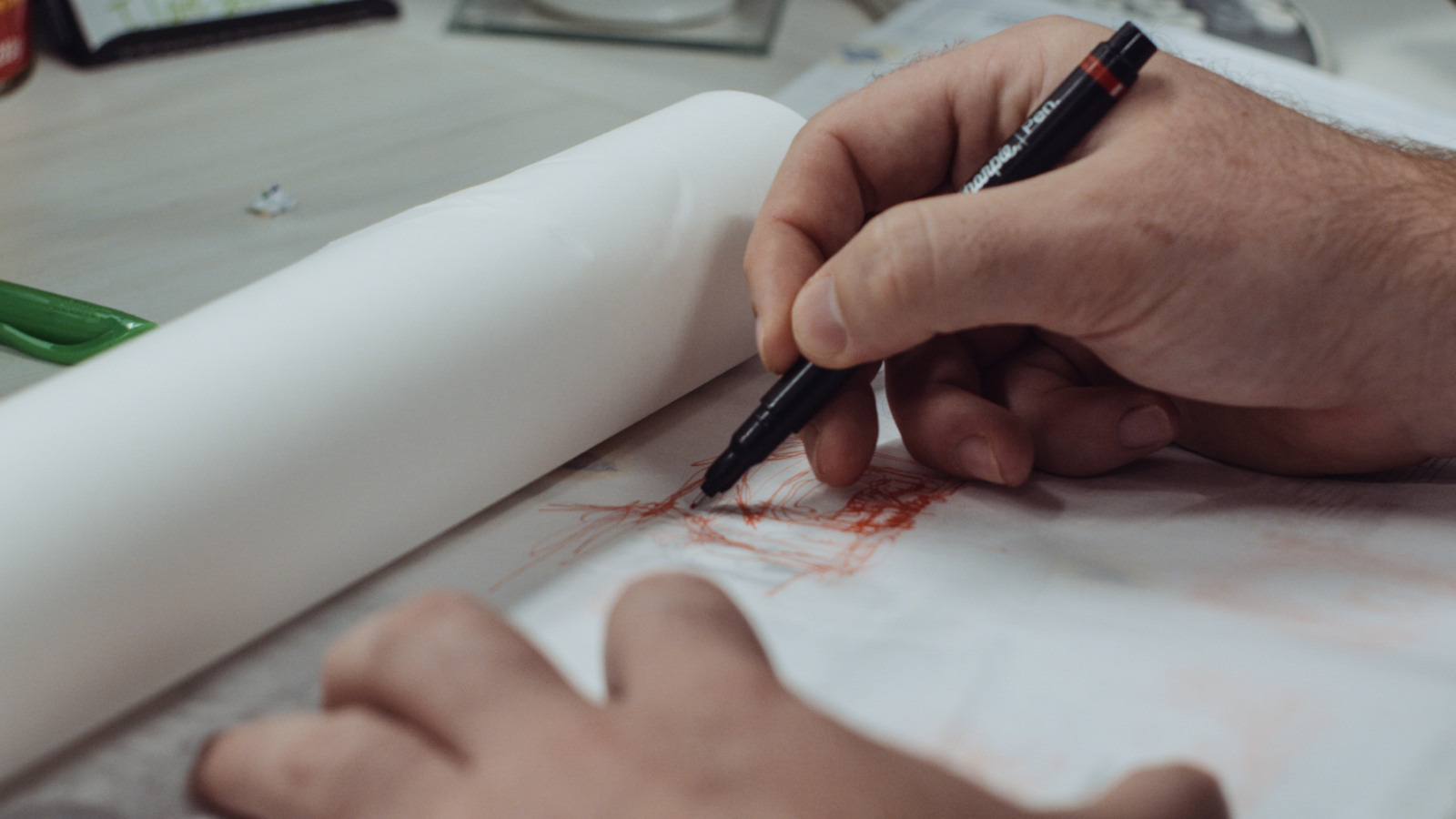 The Dos and Don'ts of Logo Design Closeup of hand drawing on paper