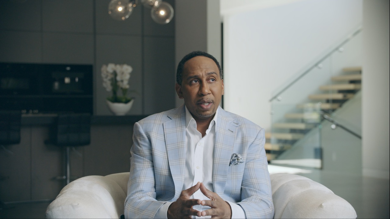Black Pop Stephen A Smith headshot wearing a light blue suit talking to the camera looking off to the side