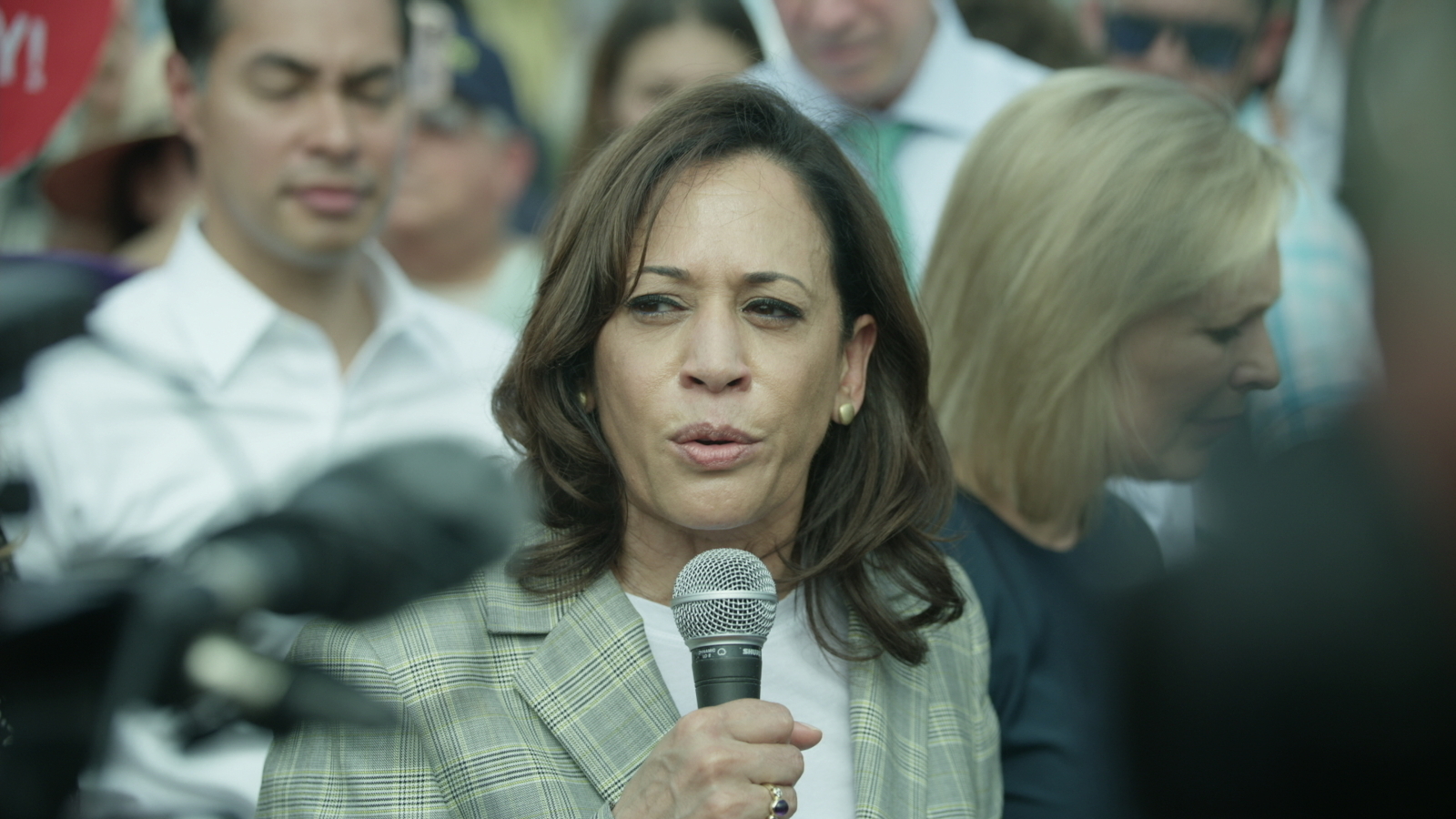 Targeting Voters Democratic Kamala Harris talking to an audience using a microphone